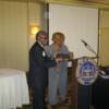 President Gloria Sweet-Love presents a plaque to Deputy Speaker Larry Turner for his outstanding contributions to the NAACP